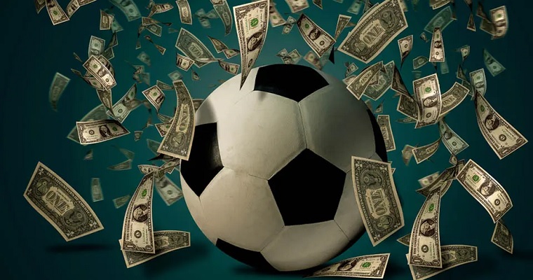 Apostas esportivas - imagem ilustrativa de uma bola de futebol cercado de notas de dinheiro vivo